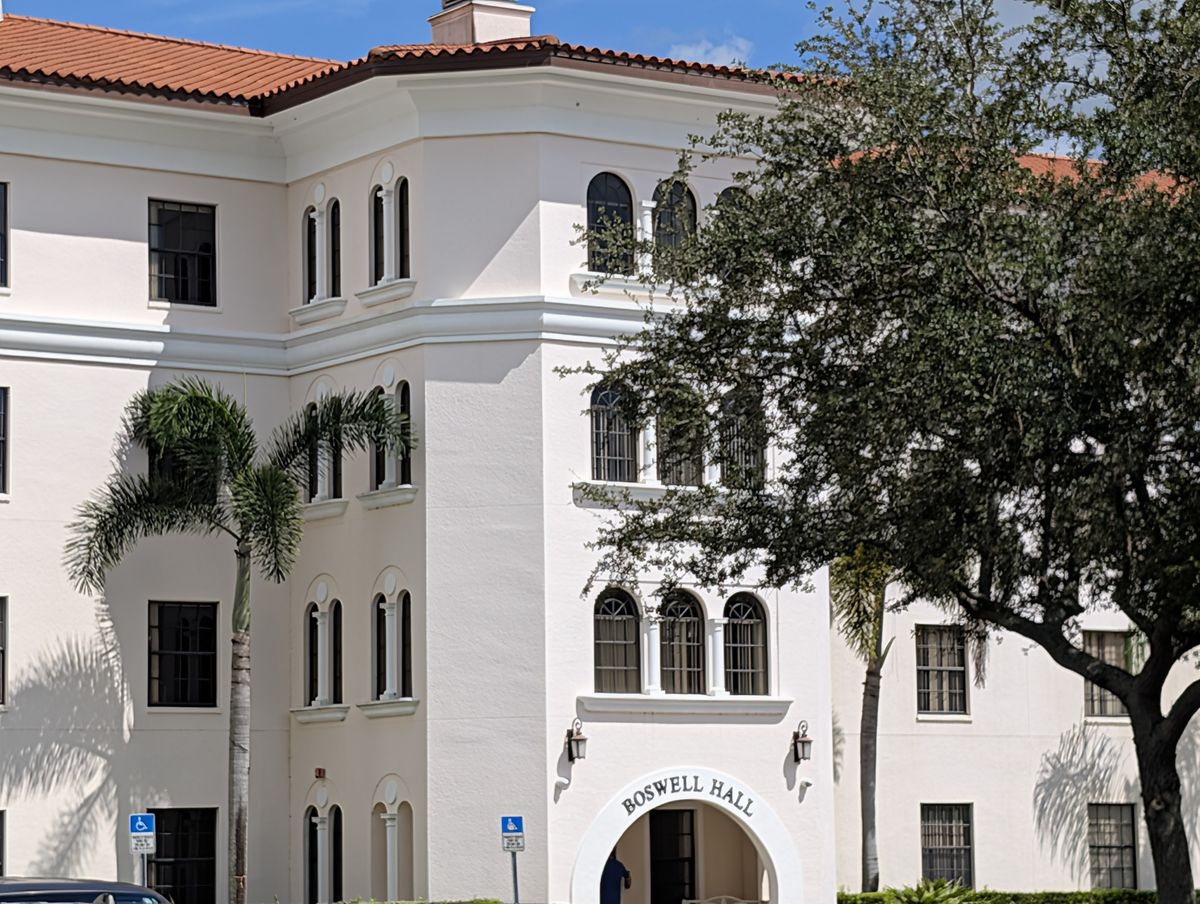 A Mediterranean-revival campus building at Florida College, framed by a live oak.