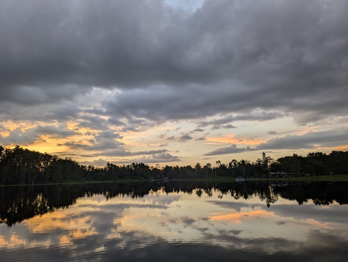 A lake at sunset near Lutz, with clouds reflected in still water.