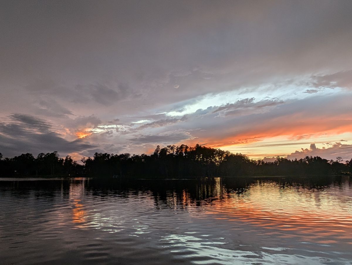 A lake at sunset under a wide sky, north of the USF and Florida College area.