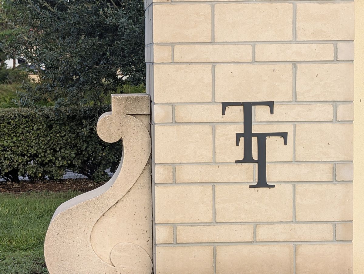 The Temple Terrace TT monogram set into a masonry wall.